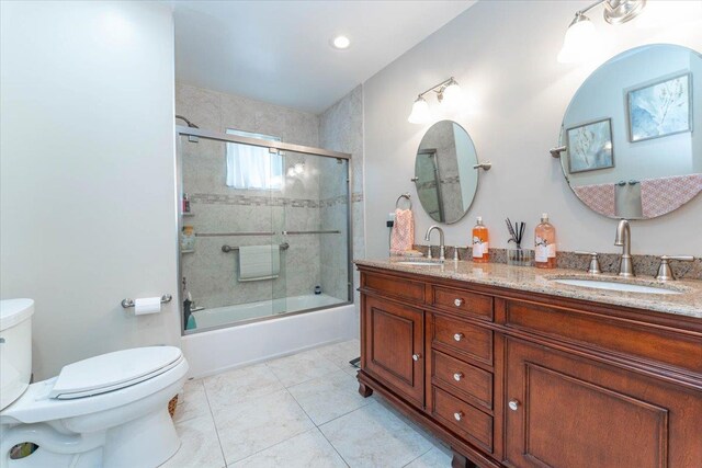 528 Longacre Ave, Woodmere, NY 11598 - full bath featuring toilet, combined bath / shower with glass door, double vanity, and tile patterned flooring
