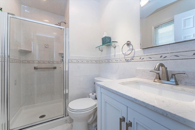528 Longacre Ave, Woodmere, NY 11598 - bathroom featuring vanity, tile walls, a shower stall, toilet, and a wainscoted wall