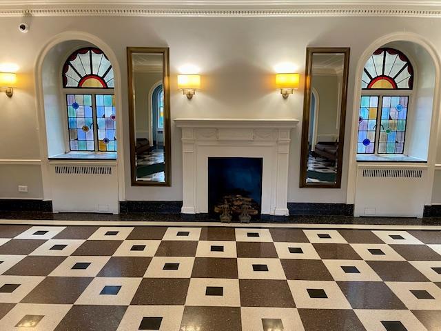 72-17 34th Ave Unit 1H, Jackson Heights, NY 11372 - unfurnished living room with a fireplace and arched walkways
