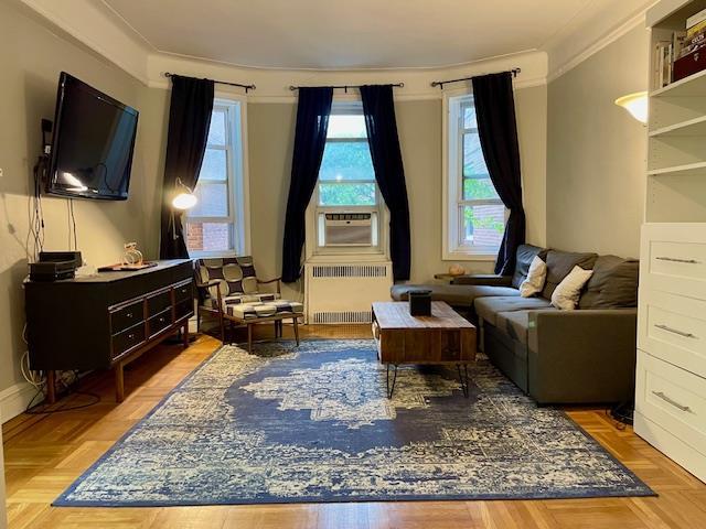 72-17 34th Ave Unit 1H, Jackson Heights, NY 11372 - living room with radiator heating unit and crown molding
