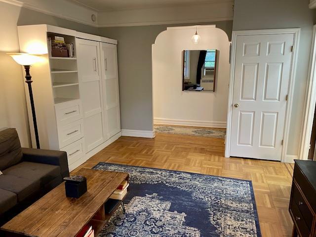 72-17 34th Ave Unit 1H, Jackson Heights, NY 11372 - living area with arched walkways and baseboards