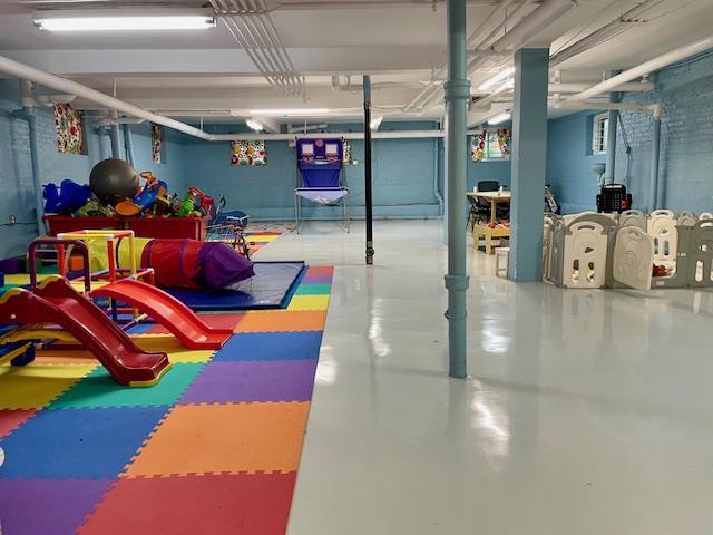 72-17 34th Ave Unit 1H, Jackson Heights, NY 11372 - playroom with finished concrete flooring