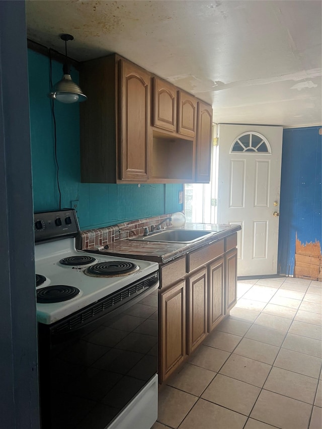 20 Rollin Ln, Brentwood, NY 11717 - kitchen featuring range with electric cooktop, a sink, light tile patterned floors, decorative light fixtures, and tasteful backsplash