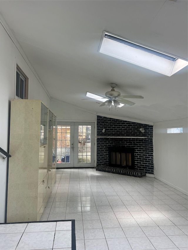 20 Rollin Ln, Brentwood, NY 11717 - unfurnished living room featuring ceiling fan, vaulted ceiling, a skylight, french doors, and light tile patterned floors