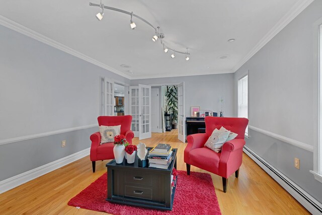 8 Mueller Mountain Rd, Putnam Valley, NY 10579 - sitting room featuring a baseboard heating unit, wood finished floors, baseboards, and crown molding