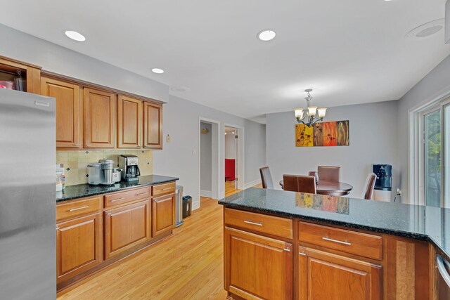 8 Mueller Mountain Rd, Putnam Valley, NY 10579 - kitchen with freestanding refrigerator, brown cabinetry, a chandelier, and recessed lighting