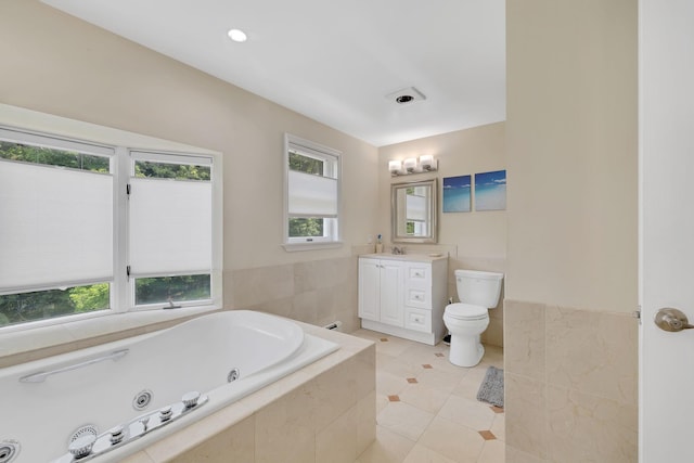 8 Mueller Mountain Rd, Putnam Valley, NY 10579 - bathroom featuring a jetted tub, vanity, toilet, tile patterned flooring, and tile walls