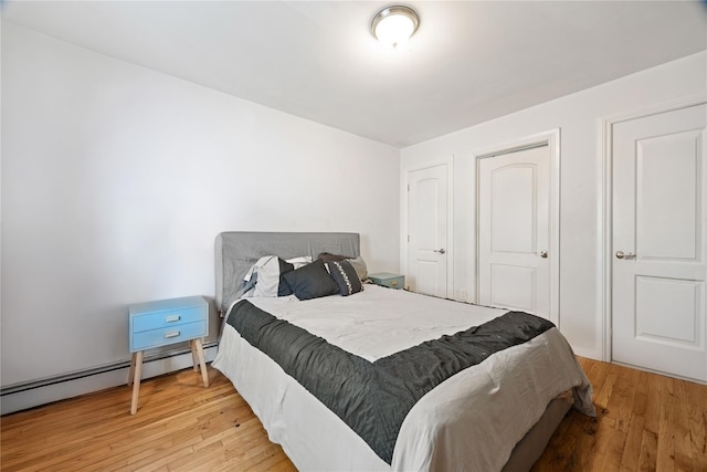 2611 Decatur Ave, Bronx, NY 10458 - bedroom featuring light wood-style flooring and a baseboard heating unit