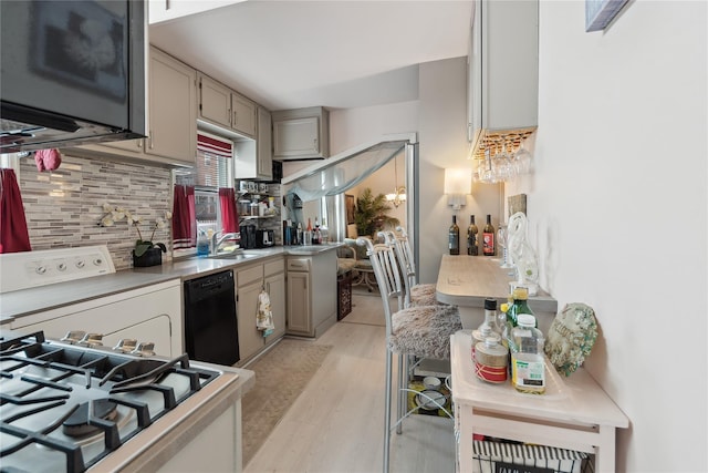 34 Alden Park Unit 34, Bronx, NY 10465 - kitchen featuring black dishwasher, washer / clothes dryer, backsplash, light wood-type flooring, and range with gas cooktop