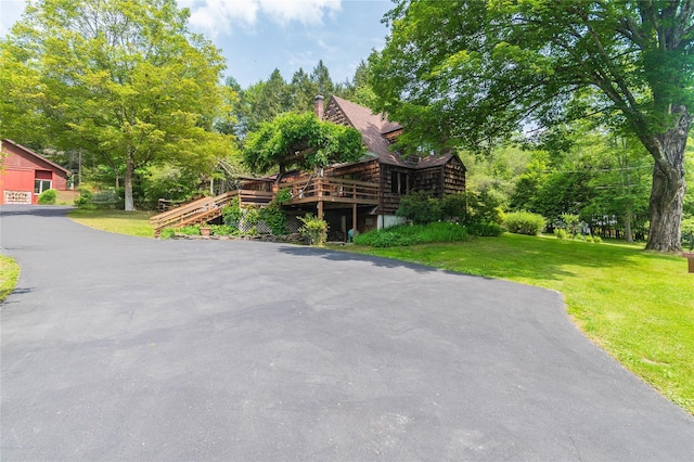 6807 State Route 42, Woodbourne, NY 12788 - log home with a front yard, a deck, and view of wooded area