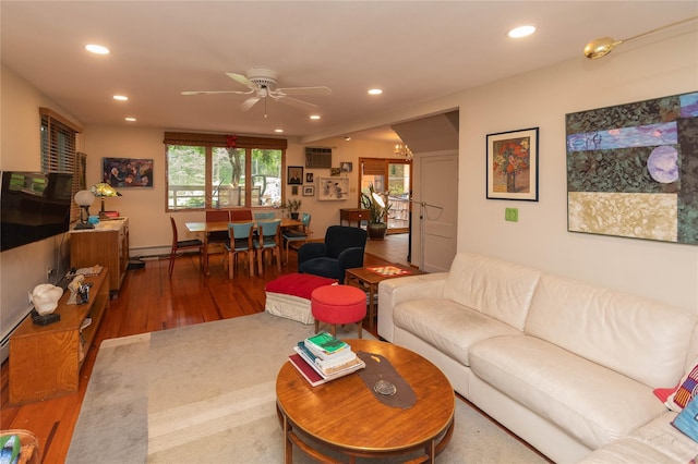 6807 State Route 42, Woodbourne, NY 12788 - living room with wood finished floors, recessed lighting, a ceiling fan, an AC wall unit, and a baseboard heating unit