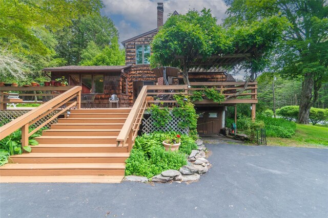 6807 State Route 42, Woodbourne, NY 12788 - view of front facade with stairs, a deck, and a chimney