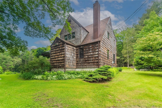 6807 State Route 42, Woodbourne, NY 12788 - view of side of home with a lawn, a chimney, and a shingled roof