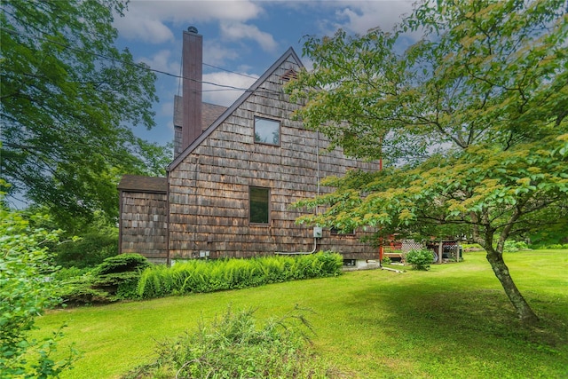 6807 State Route 42, Woodbourne, NY 12788 - view of home's exterior featuring a chimney, a lawn, and roof with shingles
