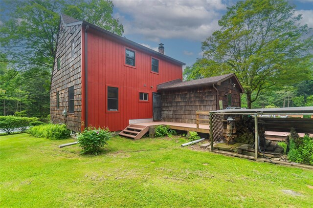 6807 State Route 42, Woodbourne, NY 12788 - rear view of property featuring a wooden deck, a chimney, and a yard