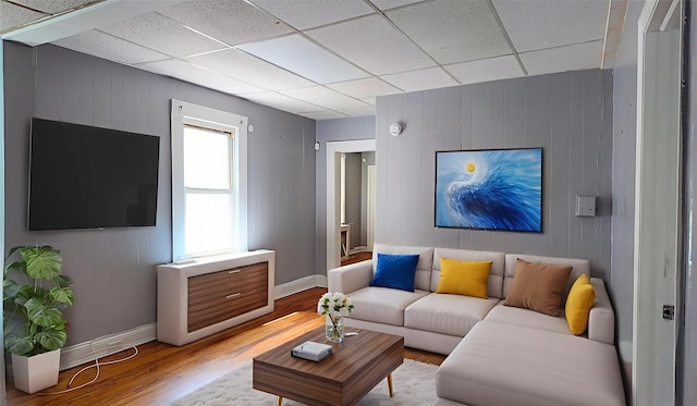 27 Charles St, Roosevelt, NY 11575 - living room with wood finished floors, wood walls, and a paneled ceiling