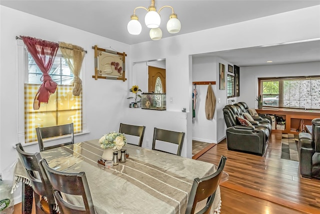 90 Charles St, Lynbrook, NY 11563 - dining space with a chandelier and wood finished floors