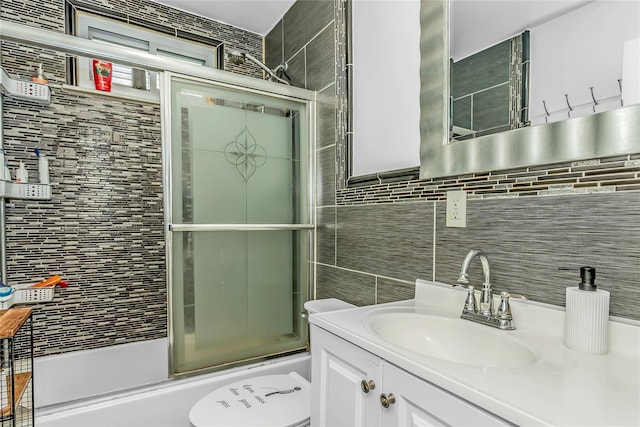 90 Charles St, Lynbrook, NY 11563 - bathroom featuring vanity, enclosed tub / shower combo, toilet, and tile walls