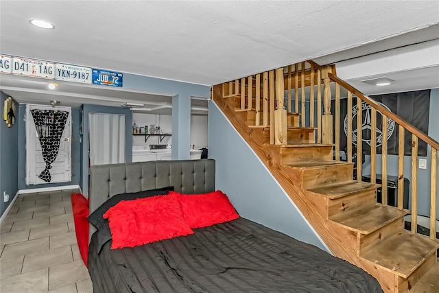 90 Charles St, Lynbrook, NY 11563 - staircase featuring washing machine and clothes dryer, recessed lighting, a textured ceiling, baseboards, and tile patterned floors