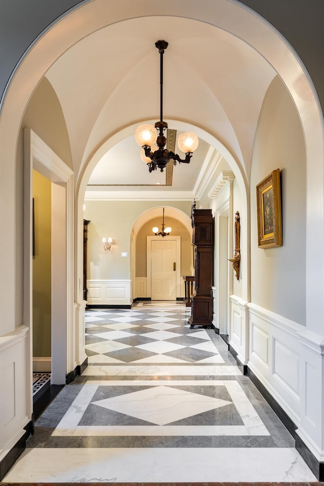 842 Sleepy Hollow Rd, Briarcliff Manor, NY 10510 - hallway with inlaid floor details, arched walkways, a chandelier, a decorative wall, and ornamental molding