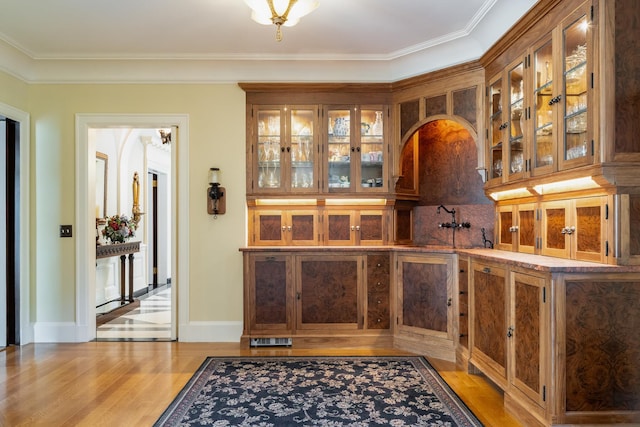 842 Sleepy Hollow Rd, Briarcliff Manor, NY 10510 - bar area featuring light wood-type flooring, ornamental molding, and tasteful backsplash