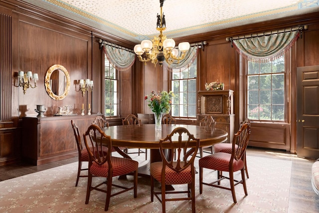 842 Sleepy Hollow Rd, Briarcliff Manor, NY 10510 - dining space featuring a chandelier, wood finished floors, ornamental molding, and wooden walls