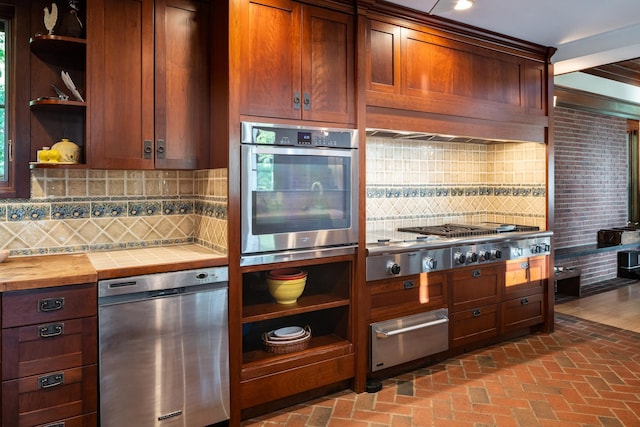 842 Sleepy Hollow Rd, Briarcliff Manor, NY 10510 - kitchen with stainless steel appliances, a warming drawer, open shelves, brick flooring, and backsplash