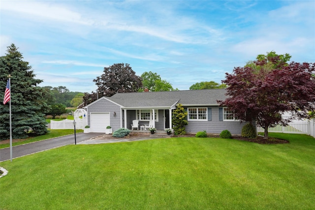 25 Jackwill Rd, East Patchogue, NY 11772 - ranch-style home with asphalt driveway, an attached garage, roof with shingles, and a porch