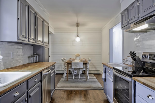 25 Jackwill Rd, East Patchogue, NY 11772 - kitchen featuring butcher block counters, appliances with stainless steel finishes, backsplash, dark wood finished floors, and pendant lighting