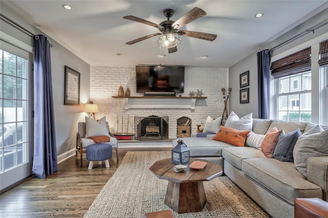 25 Jackwill Rd, East Patchogue, NY 11772 - living room with healthy amount of natural light, wood finished floors, ceiling fan, a brick fireplace, and recessed lighting