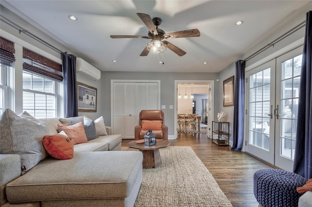 25 Jackwill Rd, East Patchogue, NY 11772 - living area featuring a wall unit AC, plenty of natural light, ceiling fan, wood finished floors, and recessed lighting
