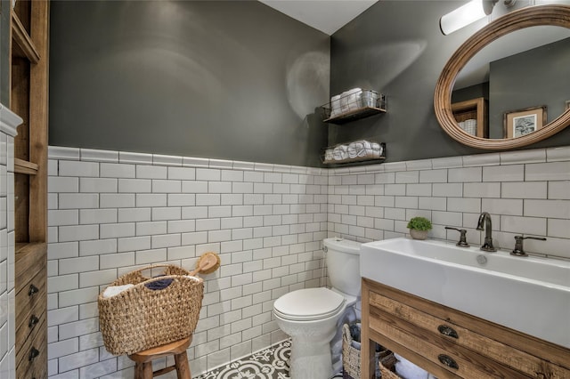25 Jackwill Rd, East Patchogue, NY 11772 - half bathroom featuring tile walls, vanity, and a wainscoted wall
