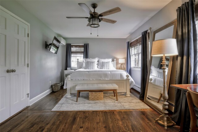 25 Jackwill Rd, East Patchogue, NY 11772 - bedroom with a baseboard heating unit, wood finished floors, and a ceiling fan