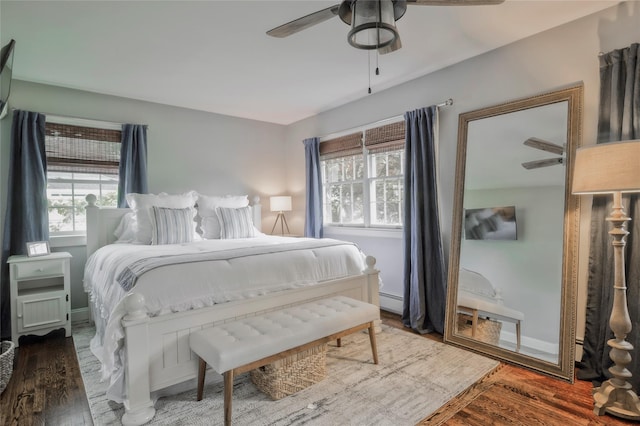 25 Jackwill Rd, East Patchogue, NY 11772 - bedroom with wood finished floors, ceiling fan, and baseboard heating