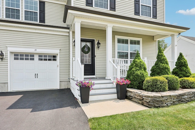 35 Laurel Cir, Goshen, NY 10924 - property entrance featuring an attached garage, covered porch, and driveway