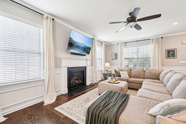 35 Laurel Cir, Goshen, NY 10924 - living room with dark wood finished floors, ornamental molding, a ceiling fan, a fireplace, and wainscoting