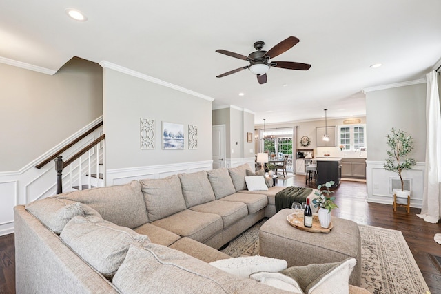 35 Laurel Cir, Goshen, NY 10924 - living area featuring a ceiling fan, crown molding, dark wood-style flooring, stairs, and wainscoting