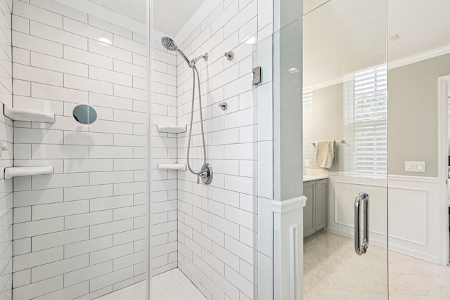 35 Laurel Cir, Goshen, NY 10924 - bathroom featuring crown molding, a stall shower, marble look tiles, wainscoting, and vanity