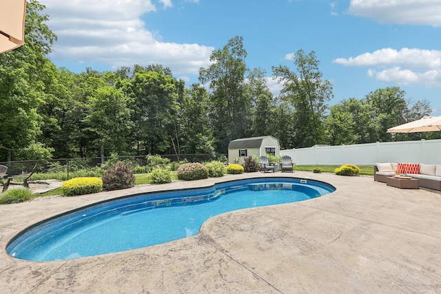 35 Laurel Cir, Goshen, NY 10924 - view of swimming pool featuring a patio area, a storage shed, a fenced backyard, an outdoor hangout area, and view of scattered trees