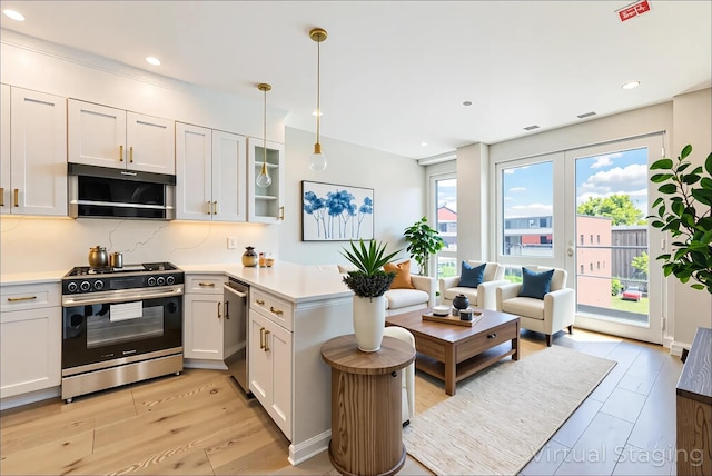 4209 Hampton St Unit 4B, Elmhurst, NY 11373 - kitchen featuring stainless steel appliances, a peninsula, light countertops, hanging light fixtures, and recessed lighting