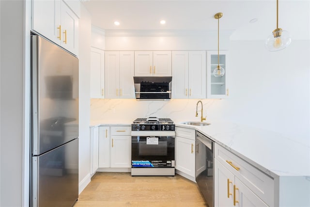 4209 Hampton St Unit 4B, Elmhurst, NY 11373 - kitchen featuring appliances with stainless steel finishes, a sink, light wood-type flooring, white cabinetry, and light stone countertops
