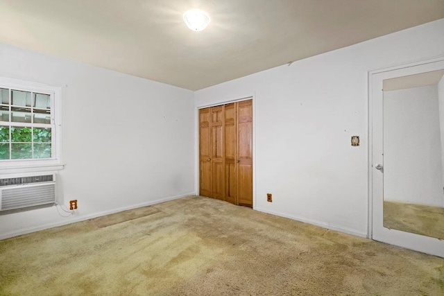 628 8th Ave, New Hyde Park, NY 11040 - unfurnished bedroom with carpet, a closet, and a wall mounted air conditioner