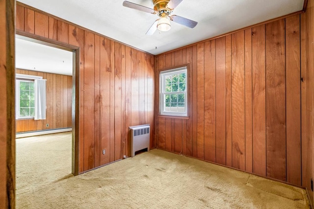 628 8th Ave, New Hyde Park, NY 11040 - spare room with radiator heating unit, a baseboard heating unit, plenty of natural light, carpet flooring, and wooden walls