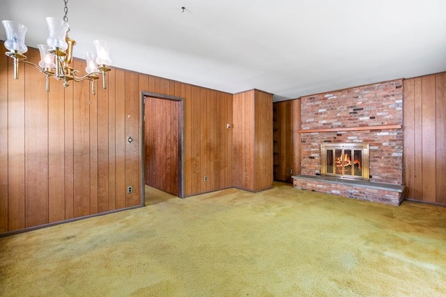 628 8th Ave, New Hyde Park, NY 11040 - unfurnished living room with a chandelier, wooden walls, carpet, and a fireplace