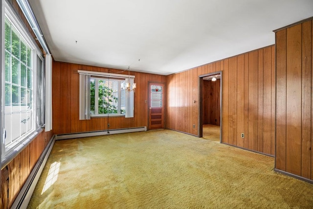 628 8th Ave, New Hyde Park, NY 11040 - carpeted spare room featuring a baseboard radiator and wooden walls