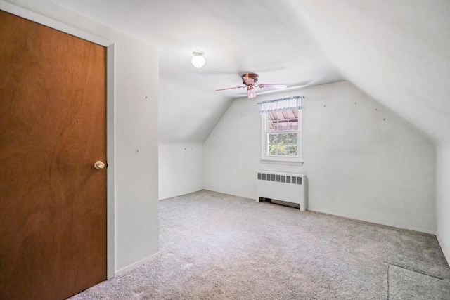 628 8th Ave, New Hyde Park, NY 11040 - additional living space with radiator, ceiling fan, carpet flooring, and lofted ceiling