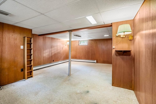 628 8th Ave, New Hyde Park, NY 11040 - basement with wooden walls, carpet flooring, a paneled ceiling, and baseboard heating