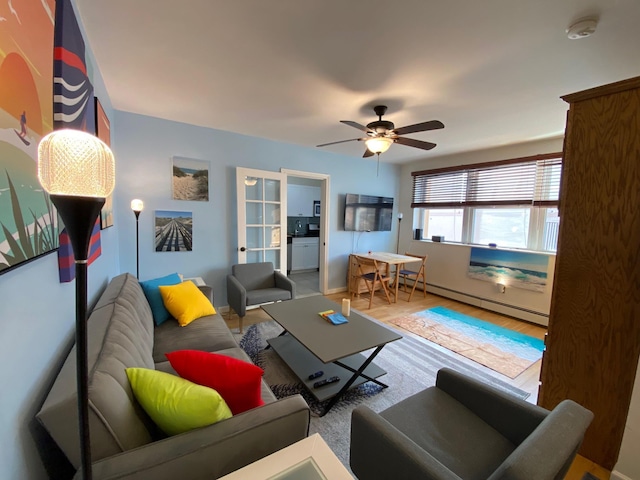 255 W Broadway Unit 303, Long Beach, NY 11561 - living room with ceiling fan, wood finished floors, a baseboard heating unit, and baseboards