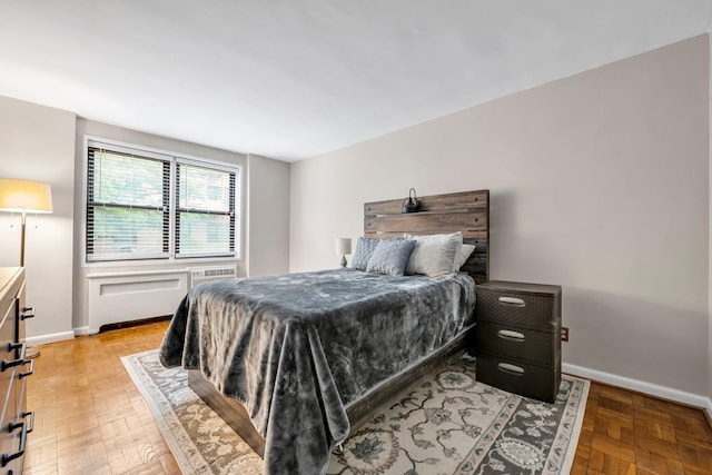 1 Birchwood Ct Unit 1N, Mineola, NY 11501 - bedroom featuring radiator and baseboards