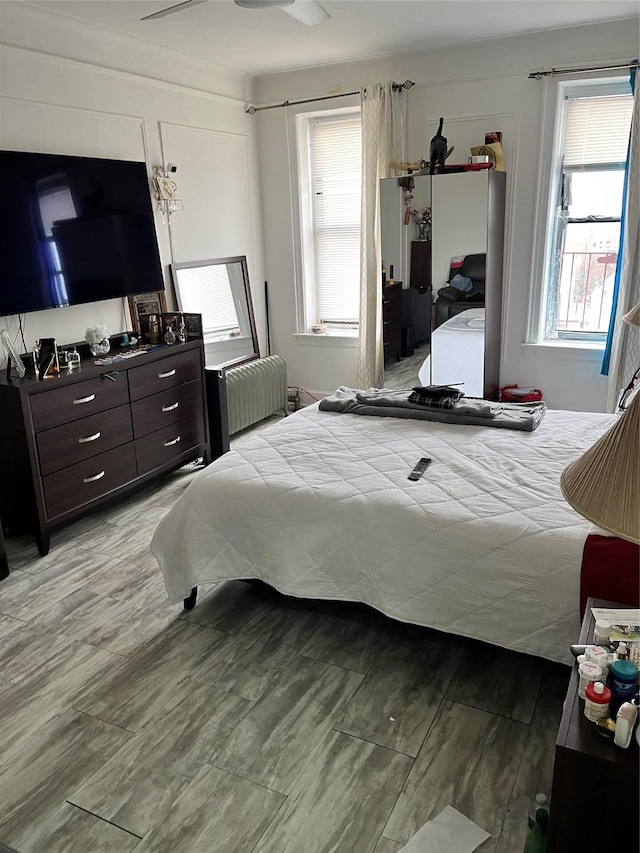 39-82 65th Pl Unit 4F, Woodside, NY 11377 - bedroom featuring radiator and multiple windows